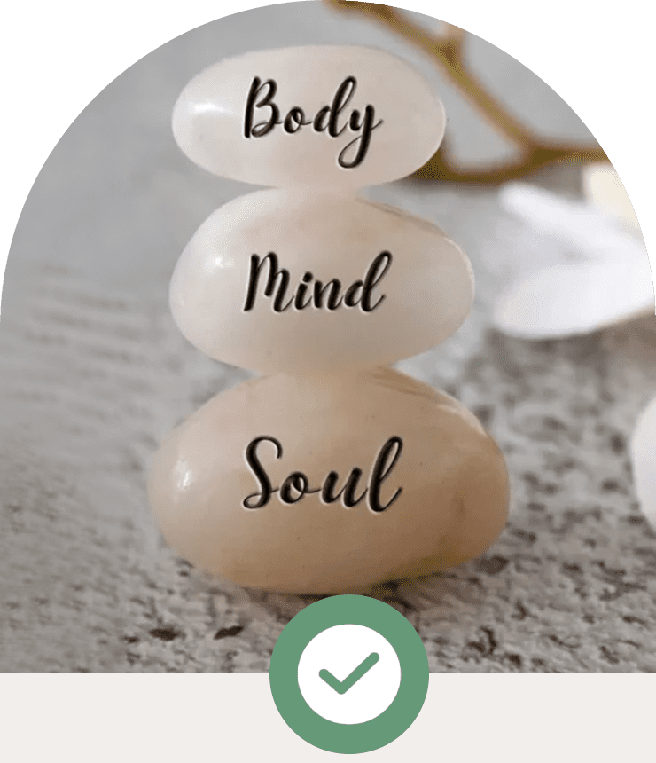 Stacked stones labeled Body, Mind, and Soul symbolizing balance.
